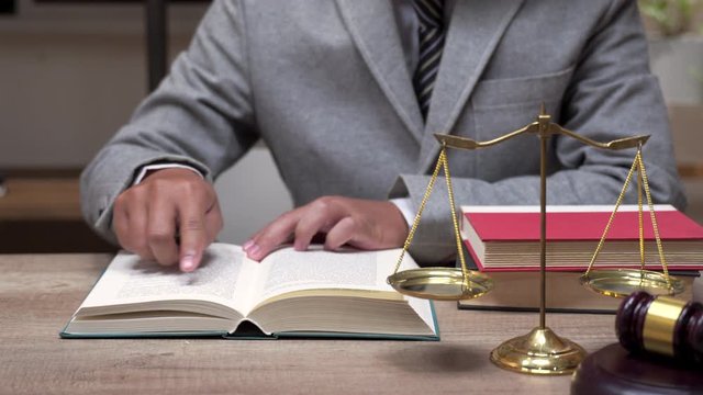 Lawyer business working with rending law book wooden gavel on tabel in courtroom. justice and law concept