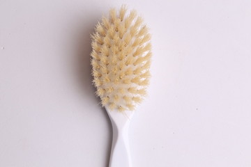 Naklejka premium white hairbrush in color background