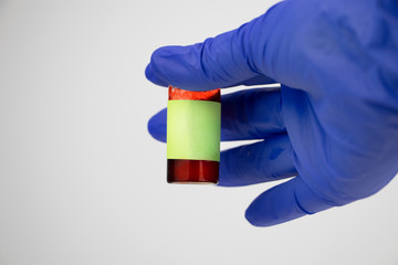 Syringe and test tube close up. The doctor does a blood sampling. Laboratory where blood tests are...