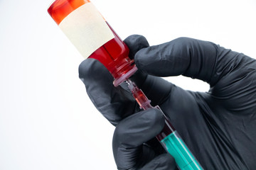 Syringe and test tube close up. The doctor does a blood sampling. Laboratory where blood tests are...