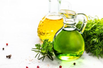 Different types of vegetable oil in glass bottles: sesame, linseed, grape oil. Place for text