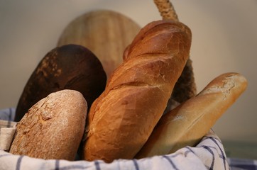 Basket with white and black bread with golden crust