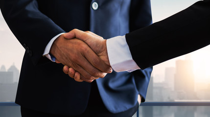successful negotiate and handshake concept, two businessman shake hand with partner to celebration...