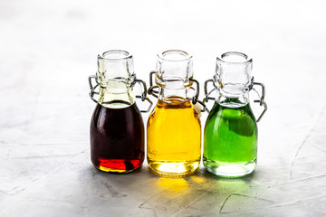 Different types of vegetable oil in glass bottles: sesame, linseed, grape oil. Horizontal