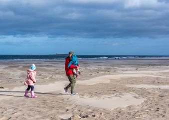 Grandfather and grandchildren on the beach