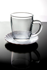 Transparent glass Cup on black and white background, close-up, space for text