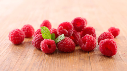 raspberry- berry fruit and mint on wood background