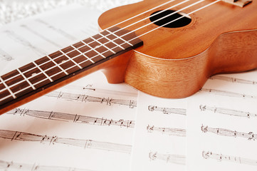 High-quality beautiful Wallpaper musical wooden instrument Ukulele with white nylon strings on the...