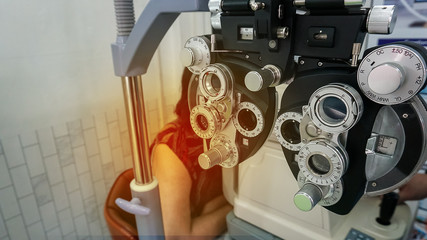 Eye test with phoropter in a clinic on a white background