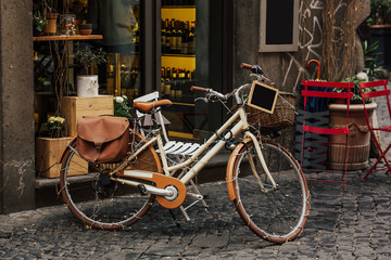 Bicycle next to a restaurant, pretty streets of small italian villages. Vintage old bike - charming...