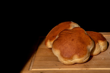 Homemade bread, bread on a wooden board, place for text.