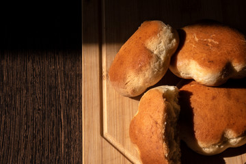 Homemade bread, bread on a wooden board, place for text.