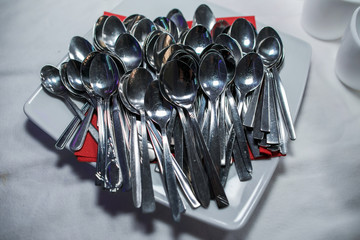 Stack of shining spoon, Abstract background of sparkling bronze spoon, kitchen equipment, Row of silver spoon background, Glittering light from kitchen equipment