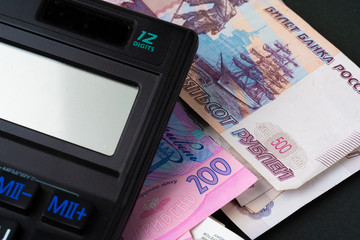 Calculator with pile of money Ukrainian Hryvnia