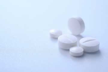 Close up of white pills on white background 