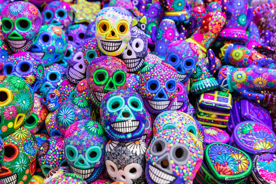 Decorated colorful skulls, ceramics death symbol at market, day of dead, Mexico.