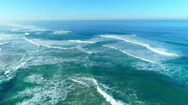 At the west seacoast of Portugal, turbulent waves surge forward consecutively.