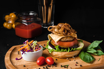 Vegetarian burger made of squash and tomato grilled courgette black background