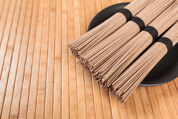 Buckwheat noodles closeup. Raw food ingredient. Dried buckwheat soba noodles. Traditional Japanese food - Image