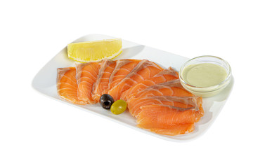 Cold appetizer before alcohol, salmon fillet salted with sauce wasabi, 9 pieces, mayonnaise, sour cream, lemon slice and olives on square plate, white isolated background Side view. For the menu