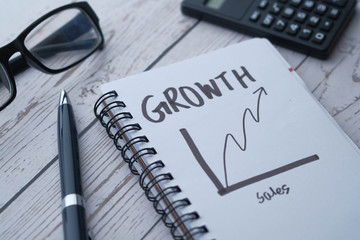 close up of growth chart on notepad on office table 