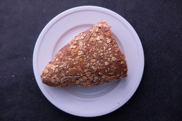 top view of slice of brown bread on plate 