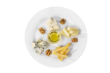 Snack to wine, sweet, a set of cheeses, honey,Walnut, aperitif before alcohol, food on plate, white isolated background view from above. For the menu, restaurant, bar, cafe