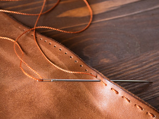 Genuine Leather. Sewing a purse. Leather work. Tools for sewing bags, wallets, clutches. Stitching....