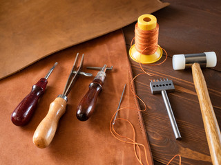 Genuine Leather. Sewing a purse. Leather work. Tools for sewing bags, wallets, clutches. Stitching....