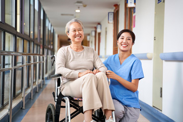 portrait of happy nursing home resident and caregiver