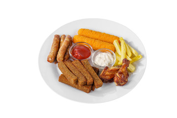 Hot appetizer croutons from rye bread, a set of sausages, cheese sticks in breading, chicken pieces, French fries, mayonnaise sauce, tar-tar, ketchup on plate, white isolated background Side view