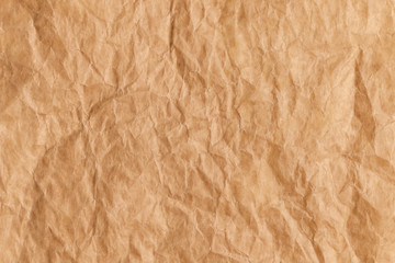 Top view of used brown baking paper with rough folds and bends. Abstract trendy culinary cooking texture background.