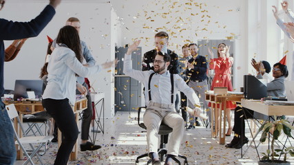 RED EPIC Happy young boss celebrates success with colleagues team and confetti at multiethnic modern office slow motion.