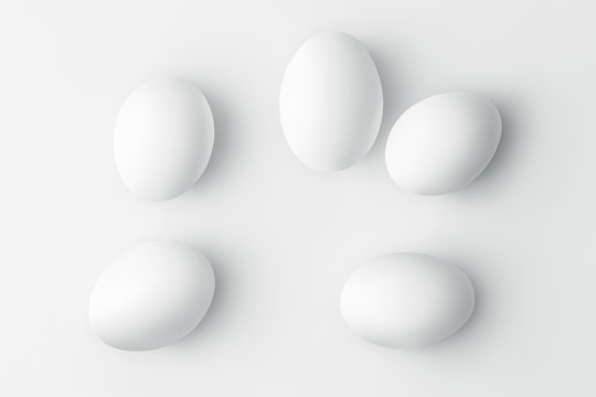 Flat lay five white chicken eggs on a white background with copy space