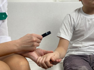 Fototapeta na wymiar Dermatologist make check-up little boy in the clinic 