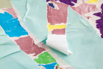 Blue torn paper placard on billboard with old grunge ripped and peeling posters texture background.