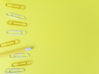 cute yellow background of paper clips on paper