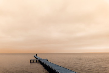 Silhouette of a lonely man on the bridge