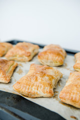 Crunchy puff pastry pie. Homemade baked pie with pears. Top view. Delicious dessert with sliced pear and chocolate powder.