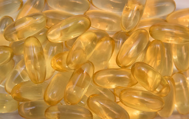 Omega capsules with fish oil with beige background.