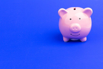 Pink piggy bank on color background. Money saving. Space for text
