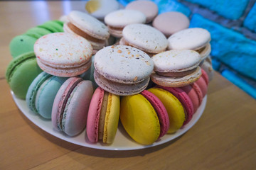 Rainbow macaroons on the table, colourful delicious bakery.