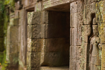 Closeup of bas-relief friezes of woman on stone wall of ancient temple in Angkor Wat, Cambodia