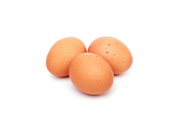 Three brown eggs isolated on white background