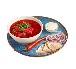 Homemade Russian, Ukrainian national soup, red borscht made of beetrot with pork ribs, close-up, isolated on white background. With clipping path.