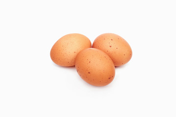 Three brown eggs isolated on white background
