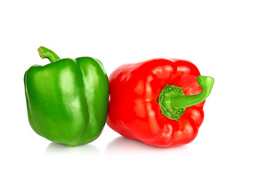 Two bell peppers: red and green isolated on a white background. Close up