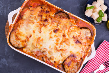 Healthy zucchini lasagna bolognese in a baking dish.Oven baked traditional Italian cuisine with mozzarella, parmesan, basil and vegetables. Copy space. Above
