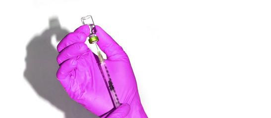 Male person in pink gloves hold vaccine bottle with syringe. Injection pharmacy concept. Medical nurse therapy. People hand health science. Horizontal banner