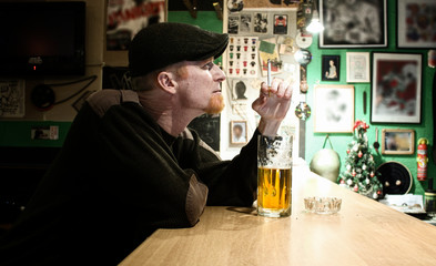 Guy smokes in the bar